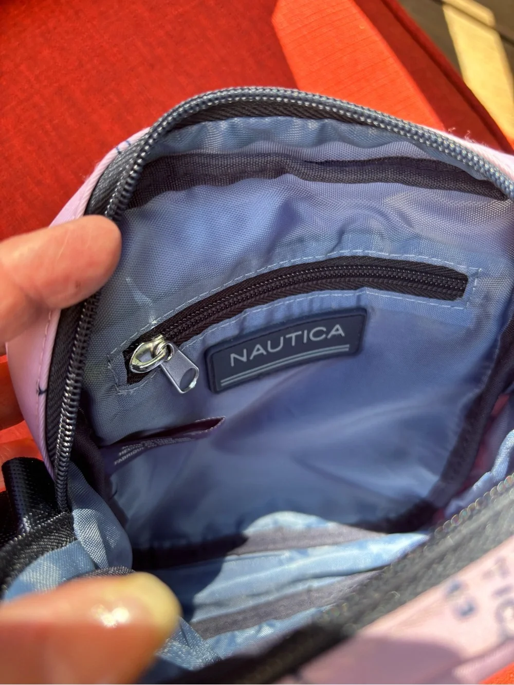 Nautica Pink Logo Print Crossbody Bag with Navy Strap and trim.